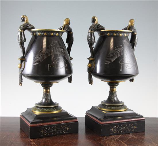 A pair of Egyptian revival patinated bronze urns, 13.25in.